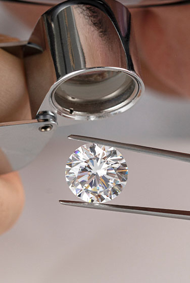Jeweler inspecting a diamond with a loupe