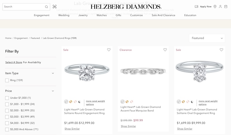 Screenshot showcasing a selection of Helzberg's lab-grown diamond engagement rings available on their website, featuring various designs and settings.